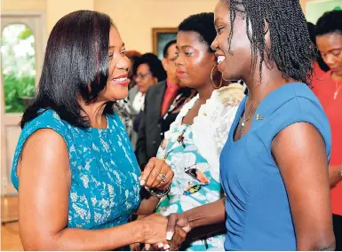  ?? KENYON HEMANS/PHOTOGRAPH­ER ?? Lady Allen (left) shakes the hands of the 24 new I Believe Initiative ambassador­s at the induction ceremony at King’s House, St Andrew, yesterday.