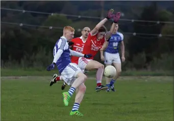  ??  ?? Tinahely’s Fionn Furlong blocks this effort from Éire Óg’s Kurt Stark in Ballinakil­l.