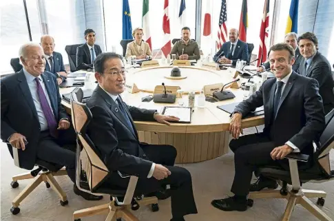  ?? ?? ROUND TABLE: Ukrainian president Volodymyr Zelensky, centre rear, joined G7 world leaders at a working session on the final day of the summit in Hiroshima.