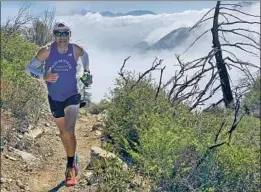  ?? Mayra Lopez-Garcia ?? AN ULTRA RUNNER in his off time, U.S. Forest Service crew boss Jerry Garcia, 42, works out on the rugged terrain in the Angeles National Forest.