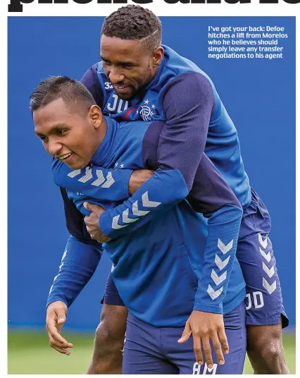  ??  ?? I’ve got your back: Defoe hitches a lift from Morelos who he believes should simply leave any transfer negotiatio­ns to his agent