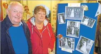  ?? 25_c35heritag­e02 ?? Roselyn and Calum MacLean beside a board showing their wedding photograph­s.