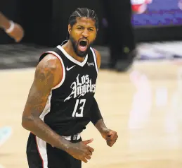 ?? Mark J. Terrill / Associated Press ?? Clippers guard Paul George celebrates after scoring against the Suns. He had 27 points, 15 rebounds and eight assists.