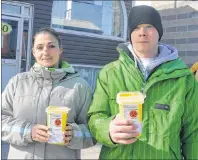  ?? NIKKI SULLIVAN/CAPE BRETON POST ?? Amanda Williams and Shane Burton, volunteers with the Ally Centre of Cape Breton, hold small safe sharp containers for disposal of needle litter. The two were walking around downtown Sydney on Wednesday on the lookout for used needles in public places...