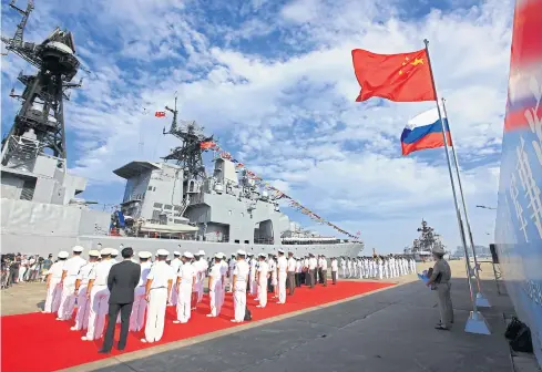  ?? AP ?? In this photo released by China’s Xinhua News Agency in 2016, officers and sailors of China’s People’s Liberation Army Navy hold a welcome ceremony as a Russian naval ship arrives in port in Zhanjiang in southern China’s Guangdong province.