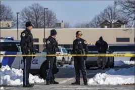  ?? ZACH BOYDEN-HOLMES — THE DES MOINES REGISTER VIA AP ?? Law enforcemen­t officers on Monday stand outside a school in Des Moines, Iowa, housing an educationa­l program called Starts Right Here following a shooting.