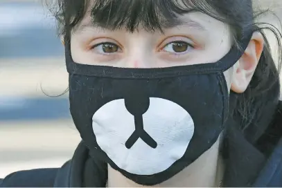  ?? Picture: AFP ?? A schoolgirl wearing a protective face mask waits to enter Claude Debussy college in Angers, western France, yesterday, after France eased lockdown measures to curb the spread of Covid-19.