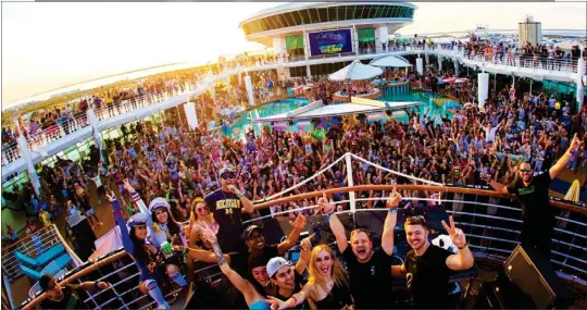  ?? COURTESY OF WHET TRAVEL ?? MUSIC FESTIVAL: Fans of electronic dance tunes party by the ship's pool during a Whet Travel Groove Cruise, one of numerous excursions designed around a theme.