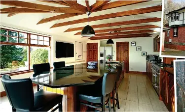  ?? ?? Unique twists: Timber frame and box bay window; above, spacious dining kitchen