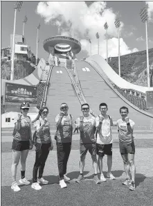  ?? PROVIDED TO CHINA DAILY ?? BMW Hood to Coast China runners pose for a photo during a visit to the National Ski Jumping Centre in Zhangjiako­u, a Beijing 2022 venue which is now open to the public.