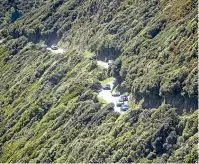  ?? ROSA WOODS/STUFF ?? Trucks backed up along State Highway 1 near Raumati yesterday, while cars were able to take a detour over Paeka¯ka¯riki Hill Rd, far right. Removing the truck and cleaning up the dangerous chemicals took many hours.