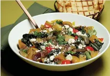  ?? Tribune News Service ?? ■ Grilled golden beets star in a fall salad, above, that makes a colorful dinner, with sauteéd beet greens, red onions, bell pepper, herbs and crumbled feta.