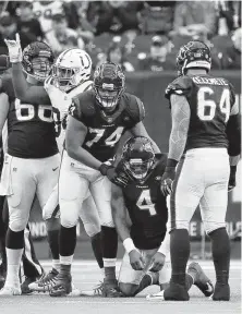  ?? Karen Warren / Staff photograph­er ?? Tackle Kendall Lamm had to help up quarterbac­k Deshaun Watson quite often Sunday since the Texans’ line was a sieve.