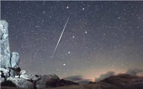  ??  ?? The annual Geminid meteor shower is famous for its fireballs, such as this one over the Mojave Desert in California on Dec. 13, 2009. WALLY PACHOLKA/AP