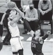  ?? MICHAEL DWYER AP ?? Boston Celtics’ Jayson Tatum shoots over Memphis’ Dillon Brooks for two of his 16 points on Wednesday.