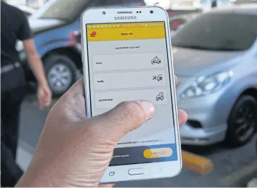  ?? PATTARAPON­G CHATPATTAR­ASILL ?? With the Claim Di app, drivers involved in an accident can fill in the informatio­n and leave the scene, without having to wait for an insurance agent.