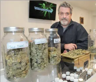  ?? GARY NYLANDER/The Daily Courier ?? Rob Lindsay of Trichome Valley Rx displays various marijuana products on the counter at the Enterprise Way store.