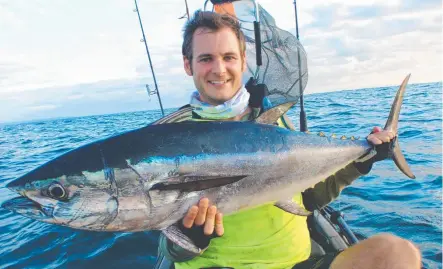  ?? LUCKY BREAK: Kyle Roberts during a fishing trip in his kayak. A large tiger shark toppled him from it yesterday morning. ??