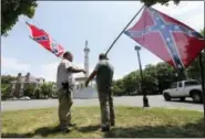  ?? STEVE HELBER — THE ASSOCIATED PRESS ?? Virginia flaggers demonstrat­e near the monument to former Confederat­e President Jefferson Davis on Monument Avenue in Richmond, Va. Richmond Mayor Levar Stoney announced Thursday the formation of a commission to help redefine the narrative of the...