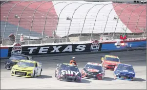  ?? RAY CARLIN - THE ASSOCIATED PRESS ?? A NASCAR official checks drivers as the race was red flagged for over 11 minutes due to an 11-car incident during a Monster Energy Cup Series race July 19at Texas Motor Speedway.