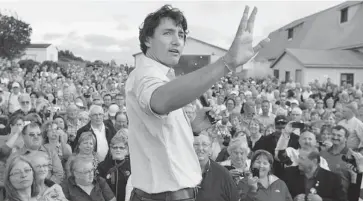  ?? ANDREW VAUGHAN /THE CANADIAN PRESS ?? Liberal Leader Justin Trudeau addresses supporters at a barn party at the home of Cardigan MP Lawrence MacAulay in St. Peters Bay, P.E.I., on Wednesday. The party is holding their summer caucus retreat in nearby Georgetown.