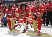  ?? TNS 2016 ?? Eli Harold (left), Colin Kaepernick and Eric Reid kneel during the national anthem before a 2016 game. Kaepernick and Reid said they were blackliste­d because of their protests during the national anthem.