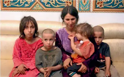  ?? AP ?? Abeer Shalgheen and her four children after being freed by the Daesh group that kidnapped them on July 25 during a raid by the extremists on the southern province of Sweida in Syria. —