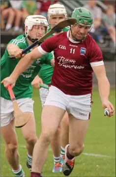  ??  ?? Pádraig Doyle of Naomh Eanna puts pressure on St. Martin’s attacker Tomás Waters.