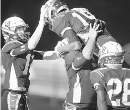  ?? STEPHEN M. DOWELL/STAFF PHOTOGRAPH­ER ?? St. Cloud players celebrate with RB Charles Robinson (top) after his third touchdown against East River Friday night. Robinson finished with 128 yards rushing on 21 carries.