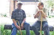  ??  ?? Claude Eady, left, a retired distillery worker who is a descendant of slave Nearis Green, with Nelson Eddy, Jack Daniels’s in-house historian. Right: Jack Daniels in the late 1800s with a man thought to be a son of Mr Green