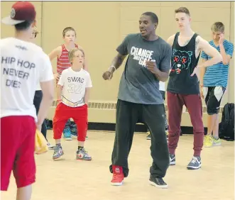  ?? COLLEEN DE NEVE/ CALGARY HERALD ?? Change the Game Project founder Bobby Mileage, centre, leads a class in Calgary on Monday during a weeklong street dance camp.