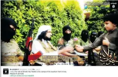  ?? TWITTER/THE ASSOCIATED PRESS FILES ?? This 2014 screen grab from an Islamic State-affiliated Twitter account purports to show senior military commander Abu Wahib handing a flower to a child in Iraq, as part of the group’s social media campaign.