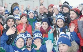  ?? AFP ?? Russian President Vladimir Putin (centre back) meets with children as they gather for a New Year performanc­e at the Kremlin’s Sobornaya Square in Moscow on Tuesday.—