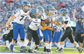  ?? ASSOCIATED PRESS FILE PHOTO ?? Youngsters play in a pee-wee football game during halftime of a preseason NFL game in 2016 between the Rams and the Cowboys in Los Angeles. USA Football is piloting the sport’s first long-term developmen­t program in the hopes of growing the game and catching up to other sports around the world.