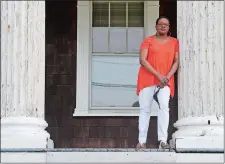  ?? SARAH GORDON/THE DAY ?? Rhonda Ward stands on the porch of her apartment building Thursday in New London. She was named New London’s first poet laureate in 2017.