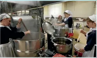  ??  ?? A screenshot from Christchur­ch film-maker Cody Packer’s documentar­y on Gloriavale shows women working in the community kitchens.