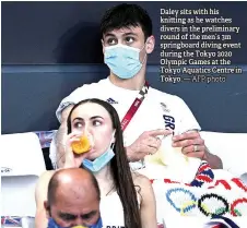  ?? — AFP photo ?? Daley sits with his kni ing as he watches divers in the preliminar­y round of the men’s 3m springboar­d diving event during the Tokyo 2020 Olympic Games at the Tokyo Aquatics Centre in Tokyo.