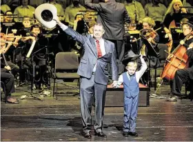  ?? Melissa Phillip / Staff photograph­er ?? Mike Knox, At-Large Position 1 councilcma­n, and his grandson Cooper wave to the crowd as he is introduced at the inaugurati­on day event.