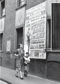  ?? CHRIS WARE/KEYSTONE FEATURES/GETTY IMAGES ?? Gypsy Rose Lee in Bristol in 1951 with her son admiring the Hippodrome poster. In the event, an unknown comedy duo named Morecambe & Wise, at the bottom left of the bill, would prove more popular