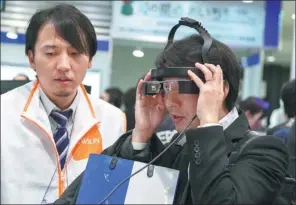  ?? PROVIDED TO CHINA DAILY ?? A visitor tries out Epson’s smart eyewear, augmented reality or AR set Moverio Pro BT-2000, at the Wearable Expo in Tokyo.