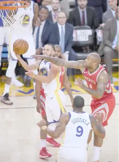  ??  ?? Stephen Curry (left) of the Golden State Warriors drives against the Houston Rockets during Game Three of the Western Conference Finals of the 2018 NBA Playoffs at Oracle Arena in Oakland. — AFP photo