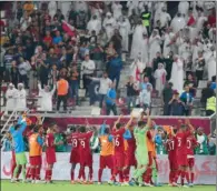  ??  ?? Qatar players thank the capacity crowd after qualifying for the semis at the Khalifa Internatio­nal Stadium on Monday.