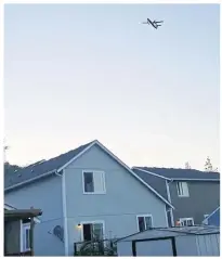  ?? AP ?? This photo taken from video provided by Courtney Junka shows the stolen plane flying over Eatonville, Washington on Friday.