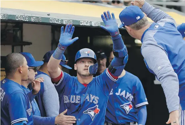  ?? — THE ASSOCIATED PRESS FILES ?? Toronto’s Josh Donaldson earns congratula­tions after hitting a home run on the team’s recent road trip out west.