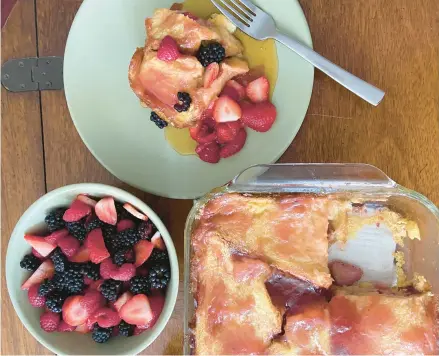  ?? JEANMARIE BROWNSON/TNS ?? Berries sprinkled between the layers adds great flavor and texture to this French toast dish.