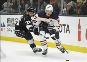  ?? MARK J. TERRILL - THE ASSOCIATED PRESS ?? Edmonton Oilers center Connor McDavid, right, moves the puck while under pressure from Los Angeles Kings defenseman Sean Walker during the third period of an NHL hockey game Sunday, Feb. 23, 2020, in Los Angeles. The Oilers won 4-2.