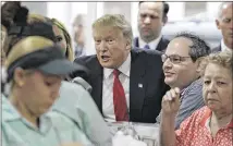 ?? JOHN LOCHER / AP ?? Republican presidenti­al candidate Donald Trump visits a restaurant in Miami on Tuesday while campaignin­g in Florida.