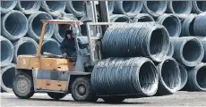  ?? AFP/GETTY IMAGES ?? An employee transports steel in Shenyang, China. Canada is strengthen­ing measures to address unfair trade in the market.