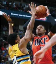  ?? JACK DEMPSEY — ASSOCIATED PRESS ?? Oklahoma City Thunder guard Russell Westbrook goes up for a shot against Denver Nuggets guard Gary Harris during the Thunder’s 106-105 win at Denver on Sunday.