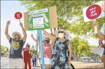  ?? L.E. Baskow Las Vegas Review-Journal@Left_Eye_Images ?? Nevadans seeking unemployme­nt benefits demonstrat­e in front of the Grant Sawyer State Office Building in Las Vegas on June 12. Even with all the problems the state has encountere­d in dealing with the crush of job losses from the pandemic, an analysis shows that Nevada is handling claims well compared with many other states.